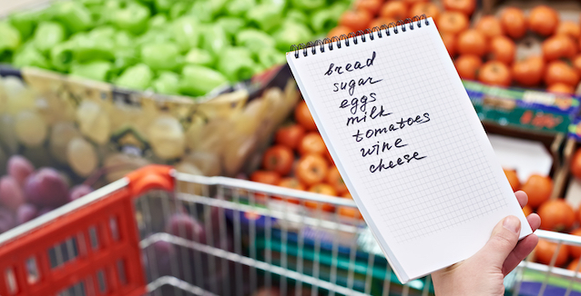 selbstgeschriebene-einkaufsliste-mit-äpfeln-und-paprika-im-hintergrund